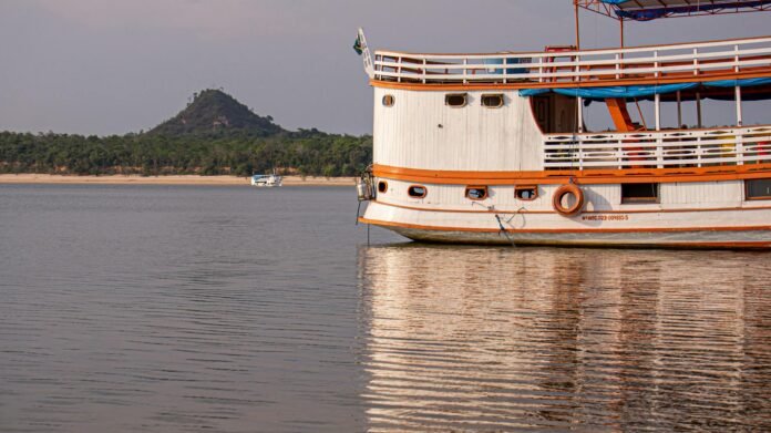 red and white boat on sea near an island
