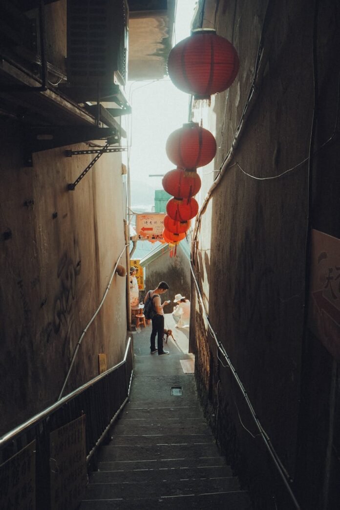 narrow alley with red lanterns at sunset