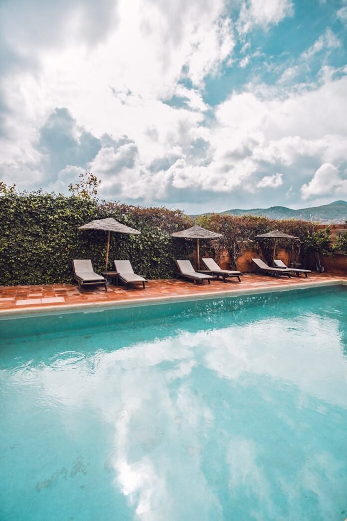 deckchairs on poolside in tropical resort