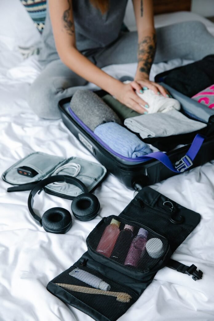 black headphones beside bag with toiletries