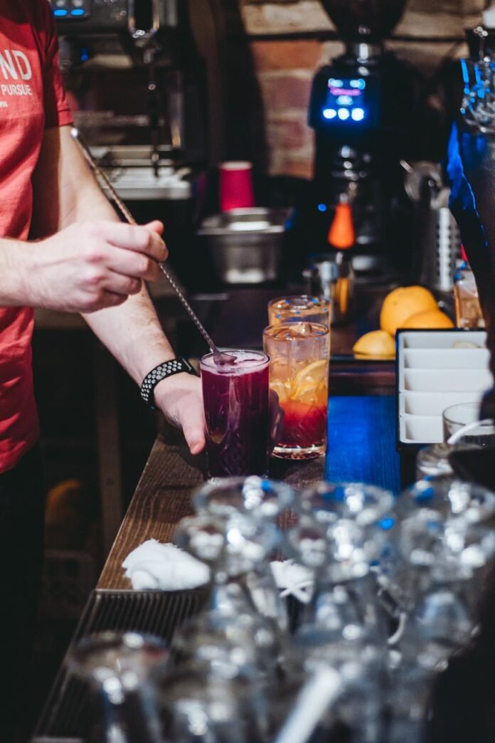 a person holding a glass with cocktail