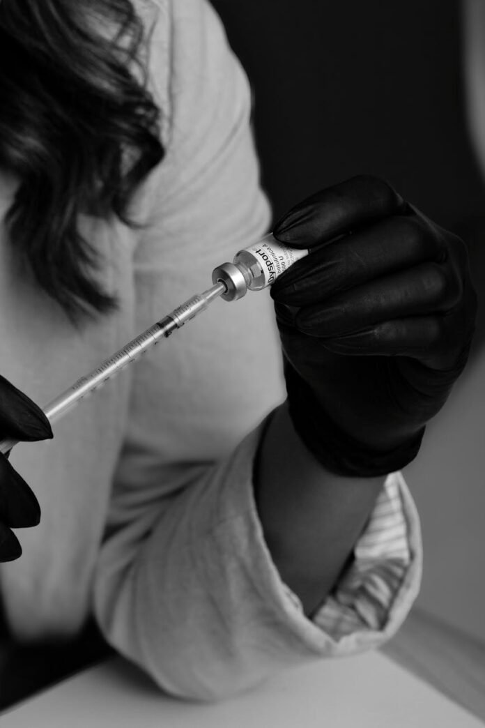 medical professional preparing injection in clinic