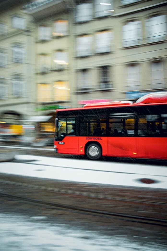 red bus on road
