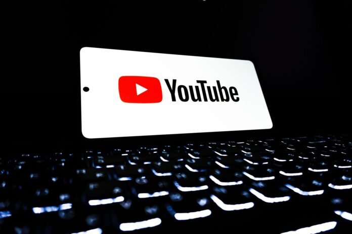 youtube logo on smartphone over keyboard